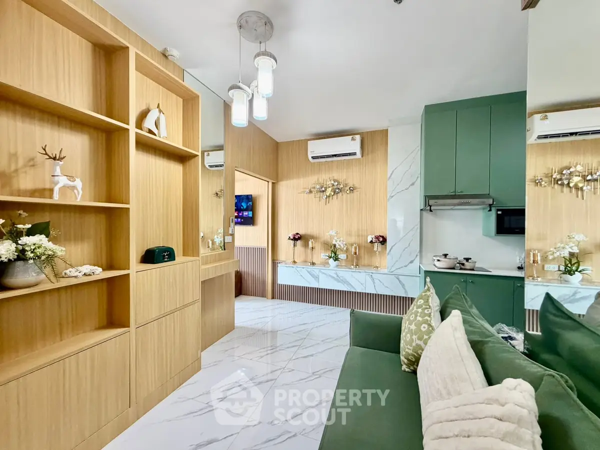 Modern living room with stylish decor and open kitchen layout, featuring elegant marble flooring and cozy seating.