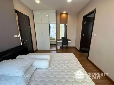 Modern bedroom with sleek design, featuring a comfortable bed and stylish furniture.