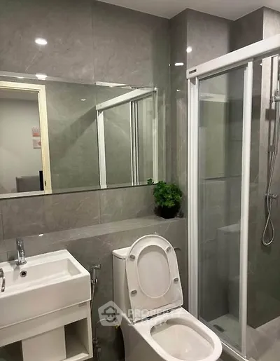 Modern bathroom with sleek fixtures and glass shower enclosure