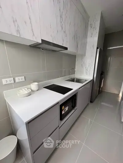 Modern kitchen with sleek cabinetry and built-in appliances in a stylish apartment.