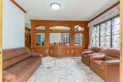 Spacious living room with elegant wooden decor and large windows