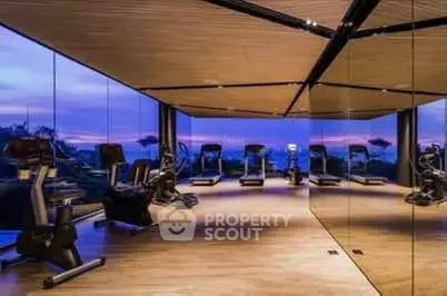 Luxurious gym with panoramic views and modern equipment in upscale building.
