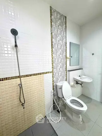 Modern bathroom with shower and toilet in tiled interior