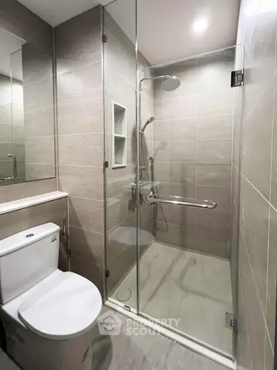 Modern bathroom with glass shower enclosure and sleek tile design