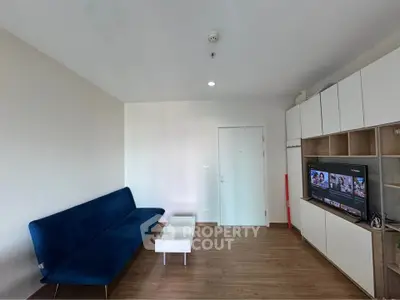Modern living room with sleek blue sofa and built-in TV unit