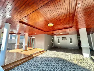 Spacious covered outdoor area with wooden ceiling and tiled flooring