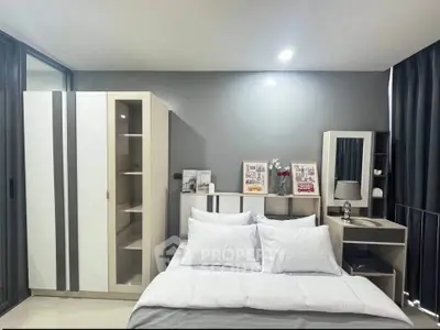 Modern bedroom with sleek furniture and stylish decor in a contemporary apartment.