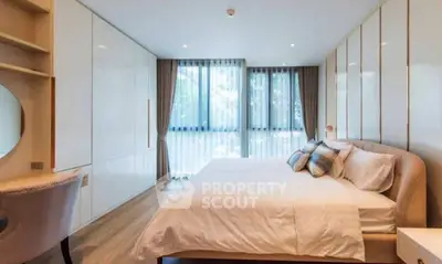 Spacious modern bedroom with large windows and elegant decor