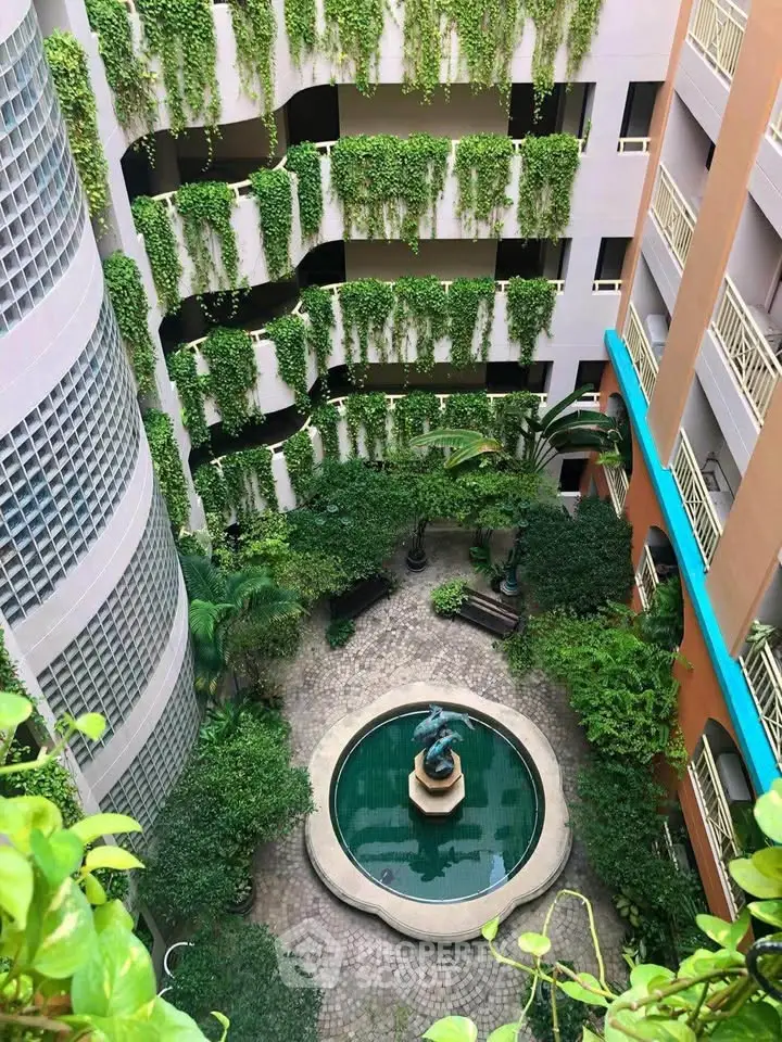 Stunning courtyard with lush greenery and elegant fountain in modern building