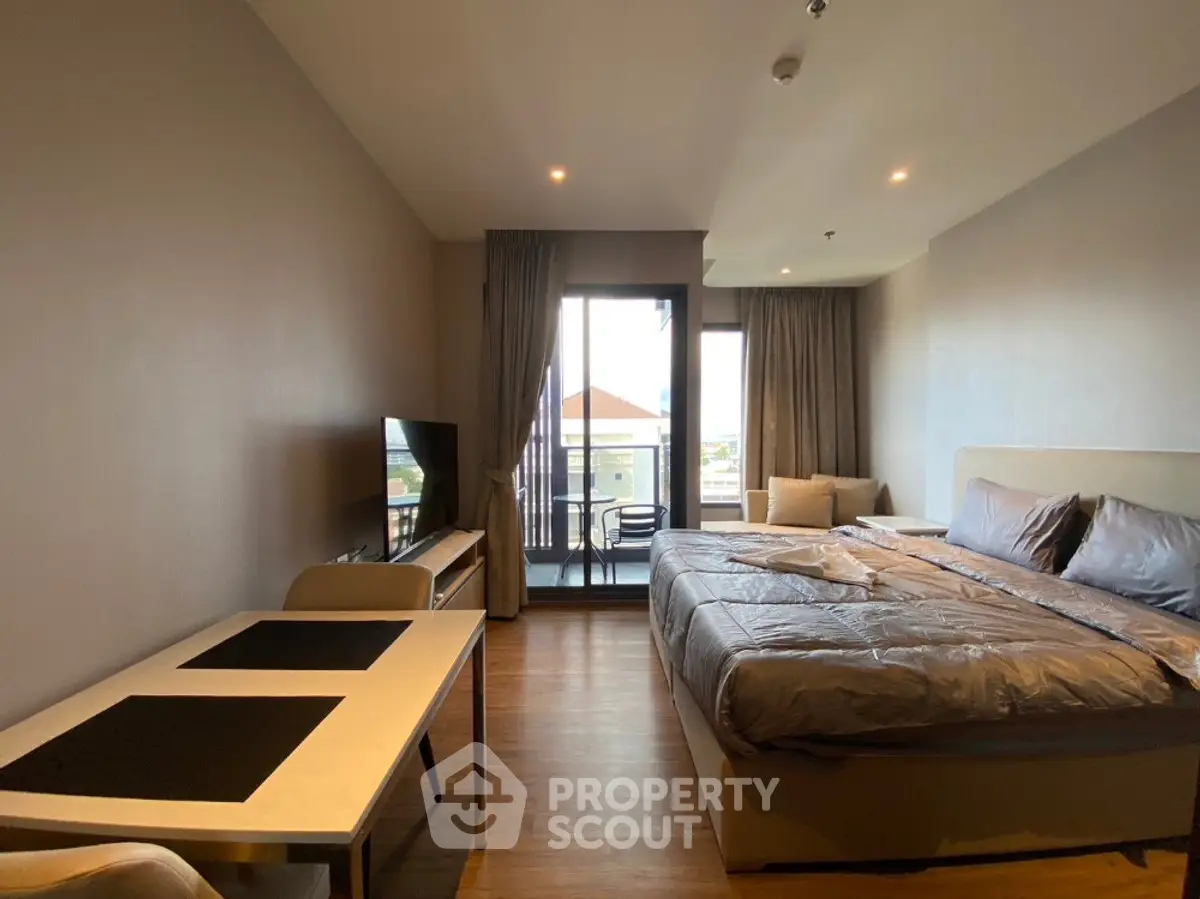 Spacious bedroom with balcony access and modern furnishings