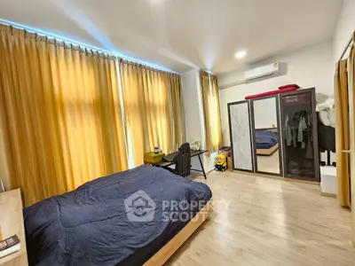 Spacious bedroom with modern decor and ample natural light