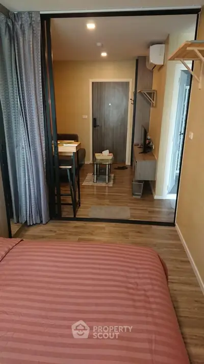 Cozy studio apartment with modern furnishings and warm wooden flooring