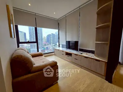Modern living room with city view, featuring cozy sofa and sleek entertainment unit.
