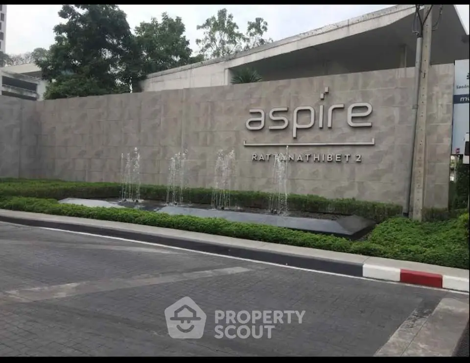Modern entrance of Aspire Rattanathibet 2 with sleek design and water feature
