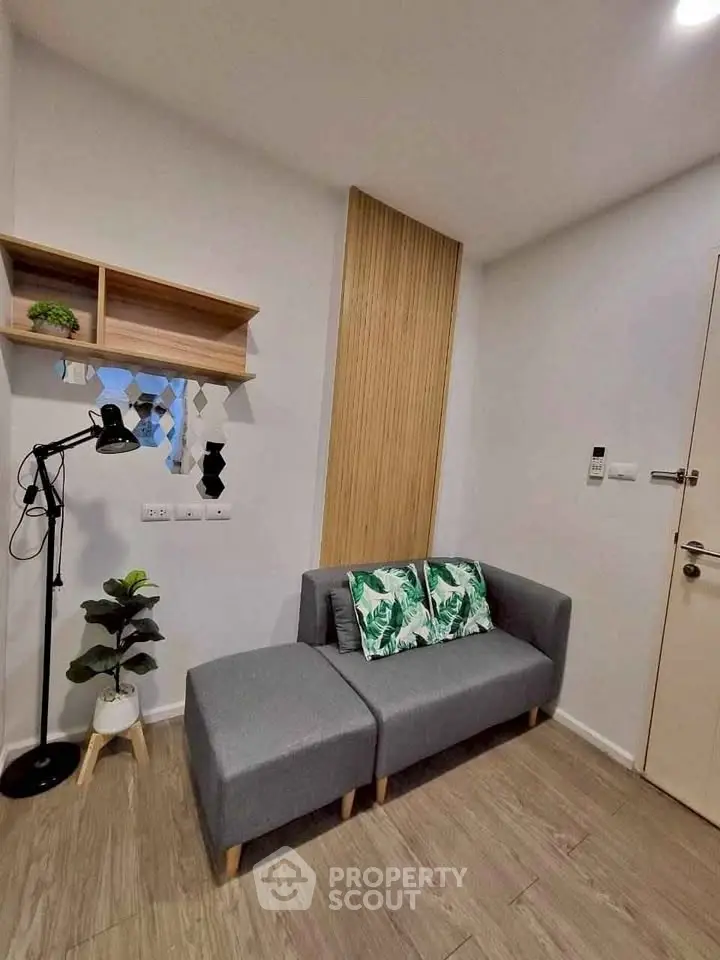 Modern living room with stylish gray sofa and decorative pillows