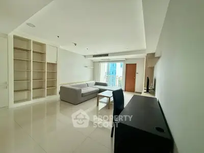 Spacious modern living room with sleek furniture and built-in shelves