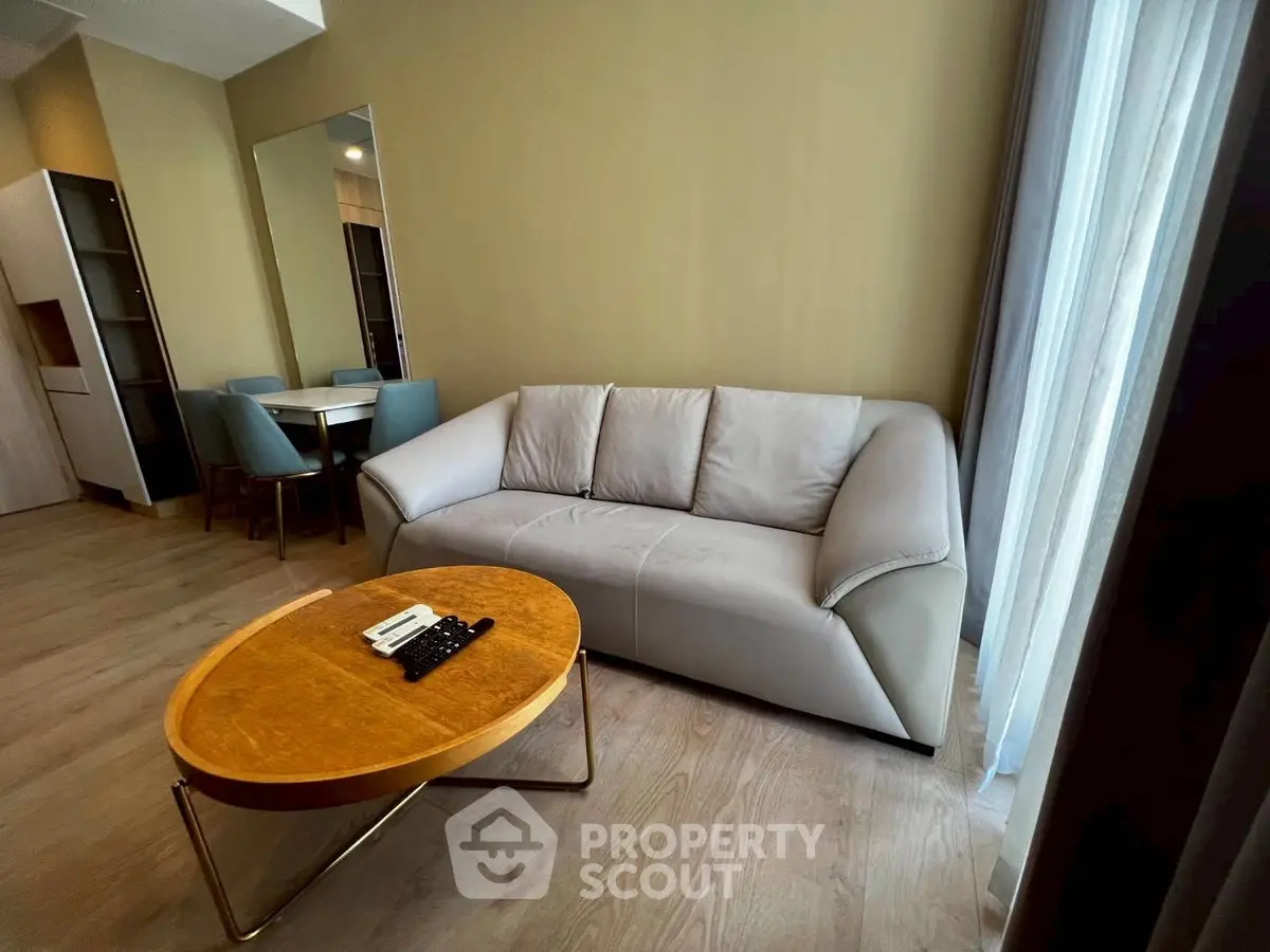 Modern living room with stylish sofa and wooden coffee table, perfect for relaxation and entertaining.