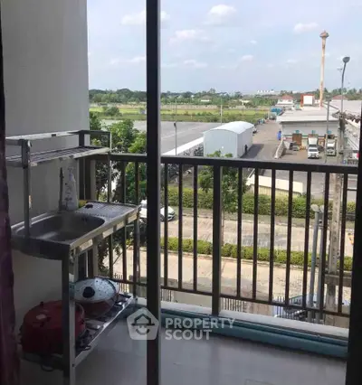 Charming balcony with outdoor sink and scenic view, perfect for relaxation and outdoor cooking.