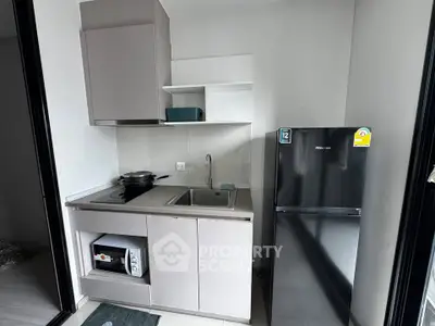 Modern compact kitchen with sleek appliances and minimalist design