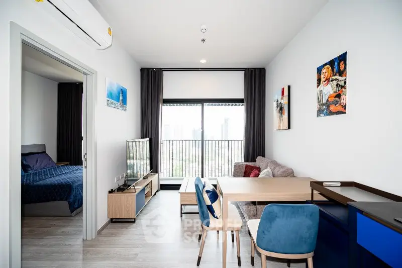 Modern living room with balcony view, stylish furniture, and open layout in urban apartment.