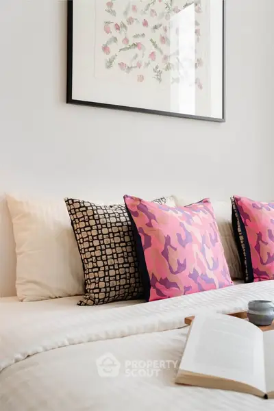 Stylish bedroom with modern decor and vibrant pillows, perfect for a cozy and inviting atmosphere.