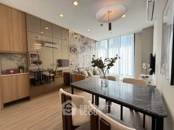 Luxurious modern living room with elegant decor and large windows.