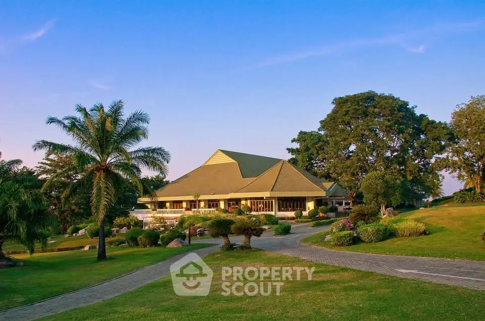 Stunning garden view of a spacious property with lush greenery and a unique architectural design.