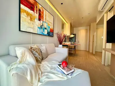Modern living room with stylish decor and open kitchen layout in a cozy apartment.
