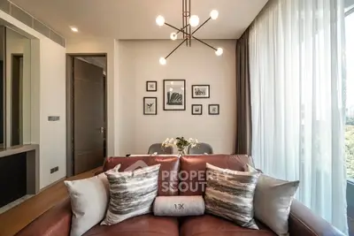 Stylish living room with modern lighting and cozy seating in a contemporary apartment.