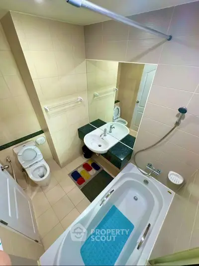 Modern bathroom with bathtub and sleek fixtures in a stylish apartment.