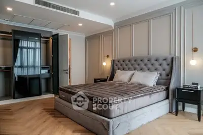 Luxurious bedroom with plush bed and elegant decor, featuring a walk-in closet.