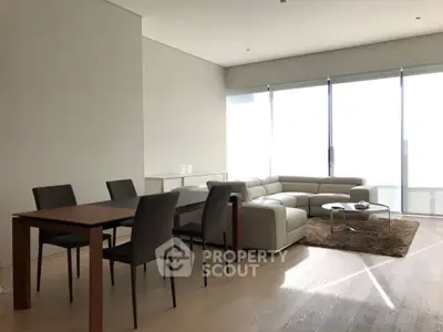 Spacious modern living room with large windows and elegant furniture