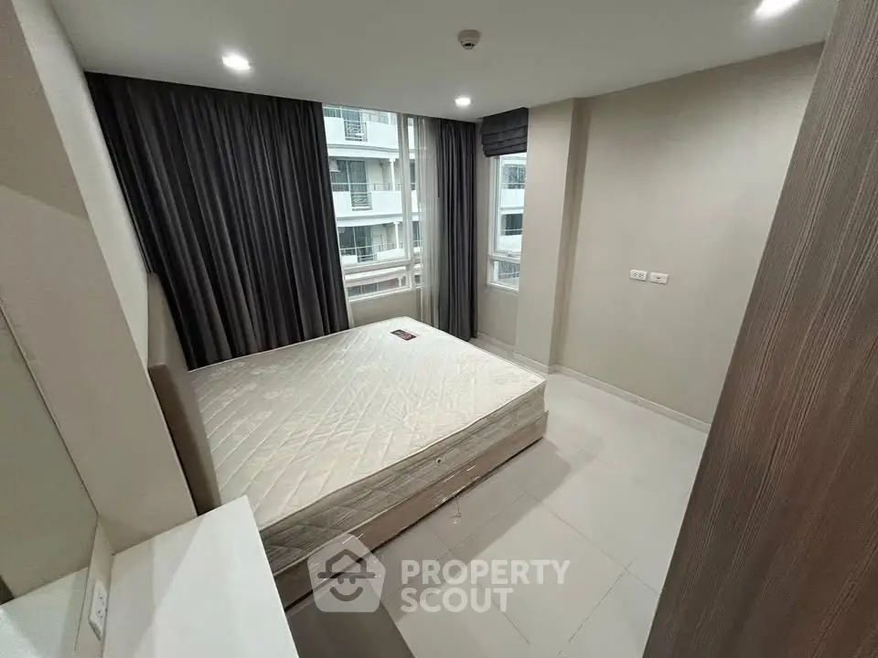 Modern bedroom with large window and minimalist design in urban apartment