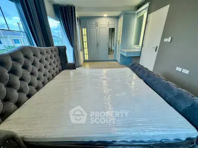 Luxurious bedroom with plush bed and elegant wardrobe in modern home.