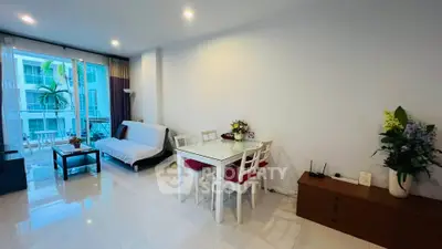 Modern living room with dining area and balcony view in a stylish apartment.