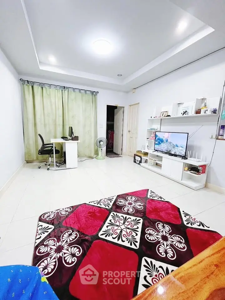 Spacious living room with modern decor and entertainment setup.