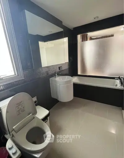 Modern bathroom with sleek fixtures and bathtub in stylish apartment.