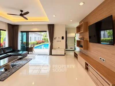 Luxurious living room with pool view, modern furnishings, and sleek design in a high-end property.