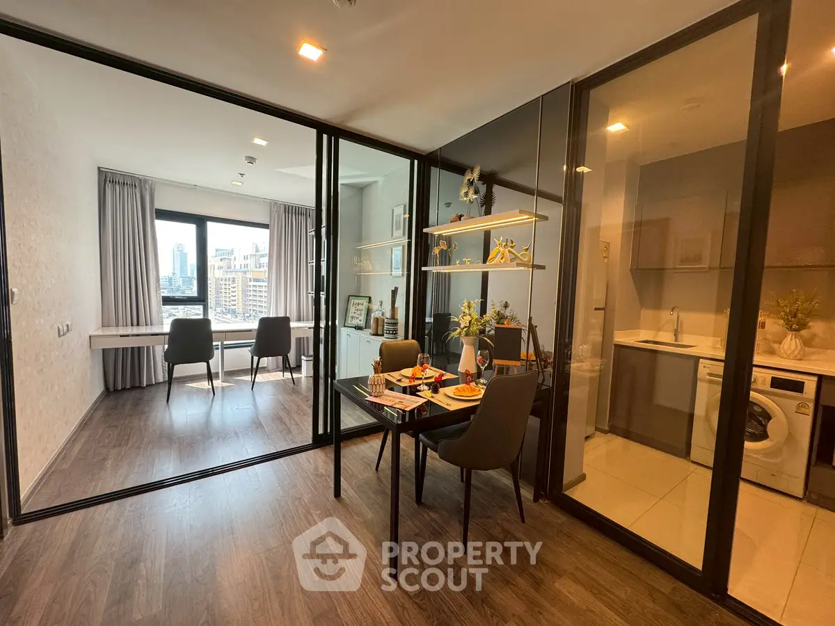 Modern apartment with glass partitions, dining area, and city view.