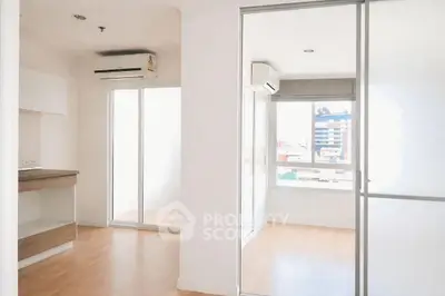 Modern apartment interior with sleek design and abundant natural light, featuring a spacious layout and air conditioning.