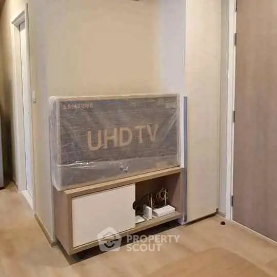 Modern living room with UHD TV and stylish wooden cabinet in a cozy apartment.