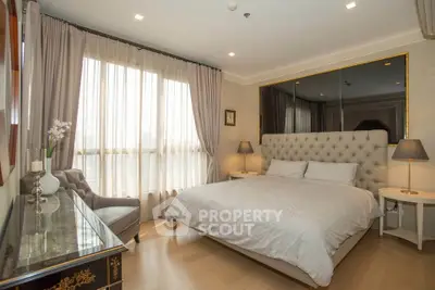 Luxurious bedroom with elegant decor and large window for natural light
