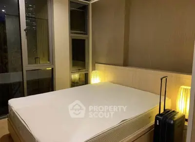 Cozy bedroom with large window and ambient lighting, perfect for restful nights.