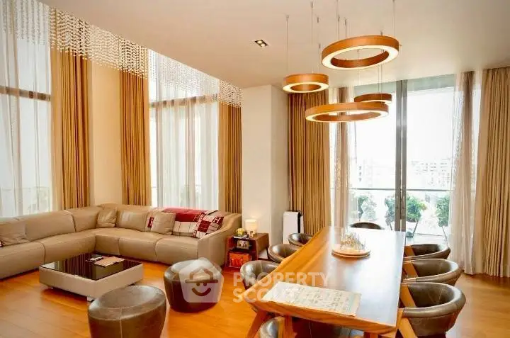 Luxurious living room with modern decor and large windows offering natural light.