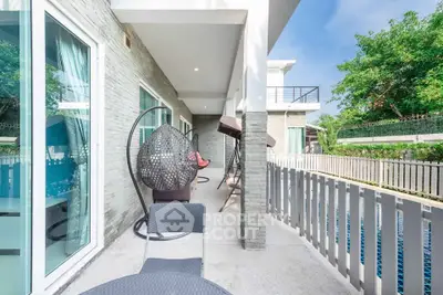 Luxurious modern balcony with pool view and stylish outdoor furniture