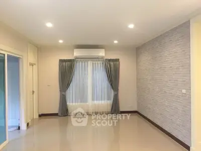 Spacious living room with modern design and large window for natural light.