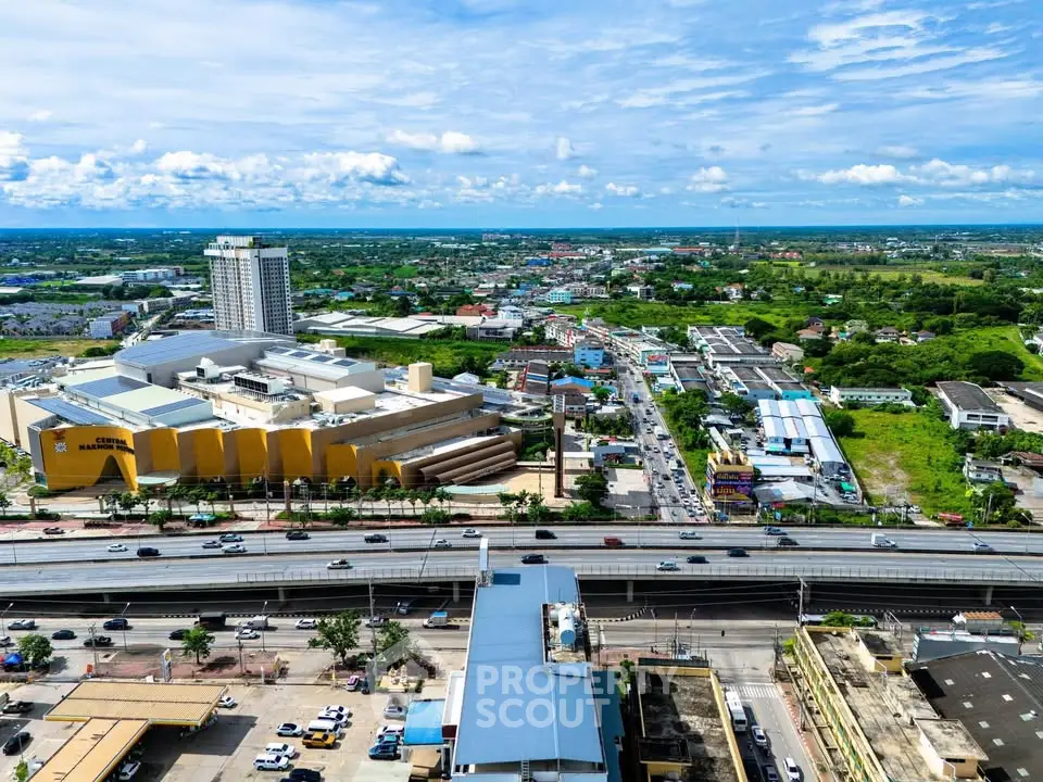 Stunning aerial view of urban landscape with modern buildings and highways, showcasing vibrant city life.