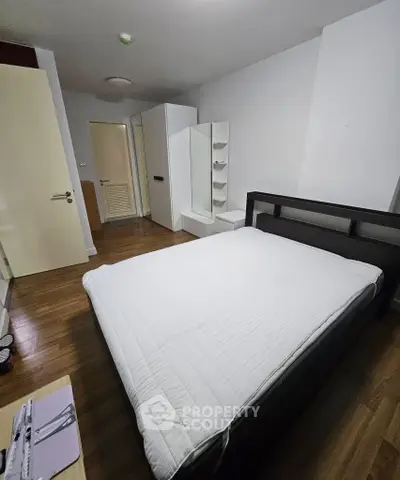 Cozy bedroom with modern furnishings and wooden flooring, perfect for restful nights.