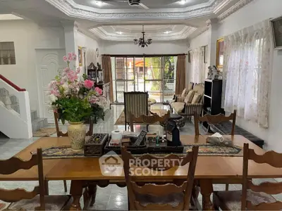 Spacious living room with elegant dining area and garden view, perfect for family gatherings.