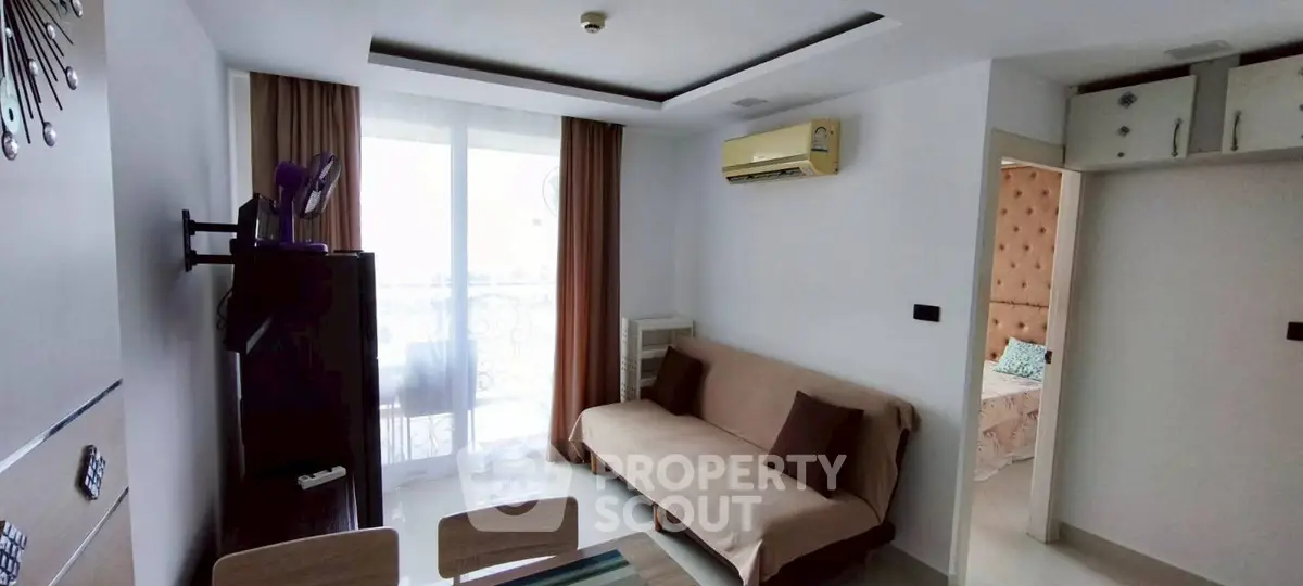 Modern living room with stylish decor and natural light, featuring a cozy sofa and elegant curtains.